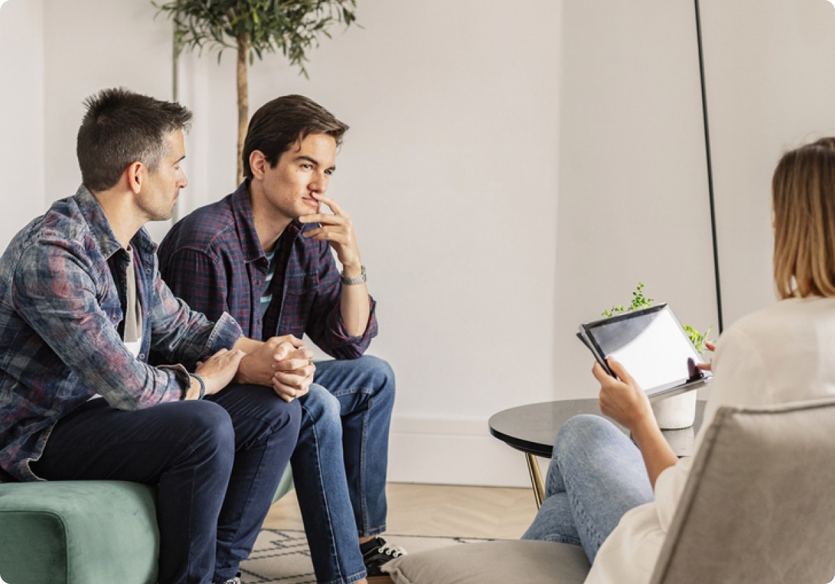 A couple talking with their therapist during a couples therapy session